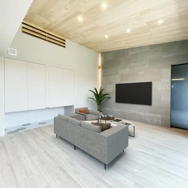 グレーのアクセントウォールに壁掛けテレビを設置したモダンなリビング